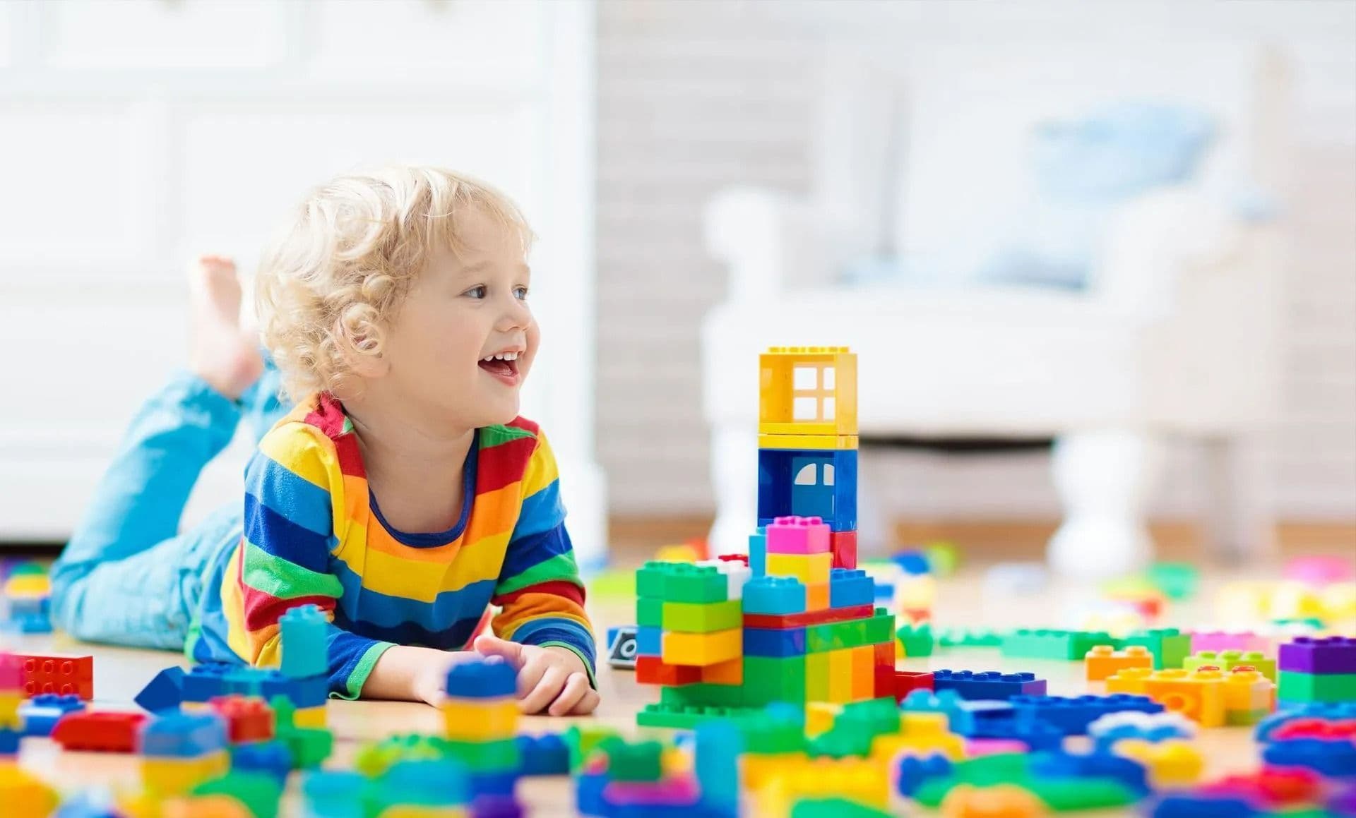 A young child enjoying colorful building blocks, from Vinings Academy’s website